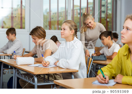 Group of school kids and teacher during lesson 90593369