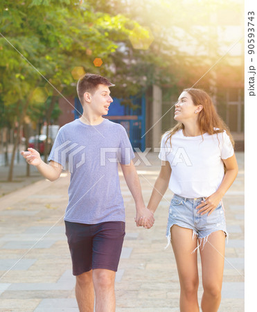 Portrait of girl and boy teenagers walking outdoors 90593743