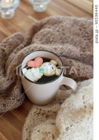 Cup of hot chocolate with figure cute marshmallows on wooden background, warm knitted plaid, cozy homely weekend, concept of seasonal winter autumn fall leasure, beverage drink 90596440