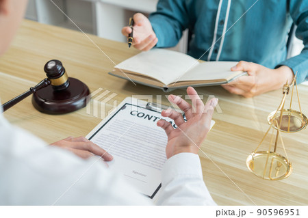 Law consultancy concept A white-shirt lawyer discussing about the contract with his dealer and writing it down on his notebook. 90596951