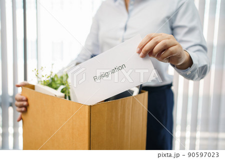 Concept of leaving job, Female employee packing personal belonging and resignation letter in box Concept of leaving job, Female employee packing personal belonging and resignation letter in box 90597023