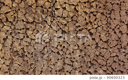Old cracked sun-burned bitumen on the roof of a house Old cracked sun-burned bitumen on the roof of a house 90600323
