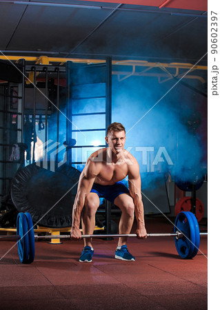 man doing exercises with barbell 90602397