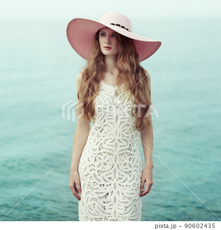 Beautiful woman in hat on the sea Beautiful woman in hat on the sea 90602435