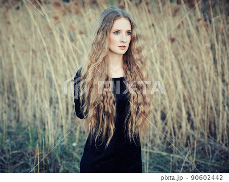 Beautiful woman on summer field. Photo on sunny day 90602442