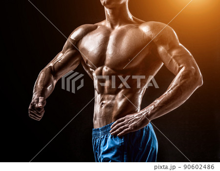 Muscular and fit young bodybuilder fitness male model posing ove 90602486