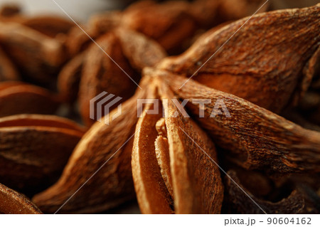 Macro photo of anise stars on wooden background Macro photo of anise stars on wooden background 90604162