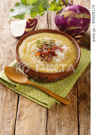Creamy Kohlrabi Soup with bacon and parmesan cheese close-up in a bowl. Vertical Creamy Kohlrabi Soup with bacon and parmesan cheese close-up in a bowl. Vertical 90608170