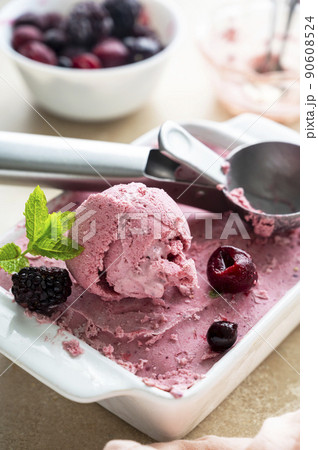 Pink ice cream scoop close up. Homemade pink healthy sorbet with banana and berry, ice cream refresing treat Pink ice cream scoop close up. Homemade pink healthy sorbet with banana and berry, ice cream refresing treat 90608524