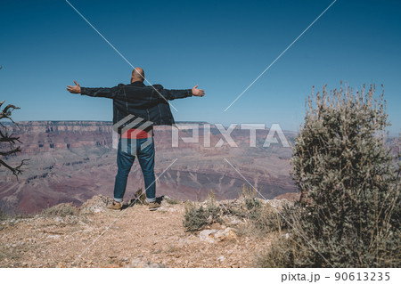 Faceless male hiker on mountain slope 90613235
