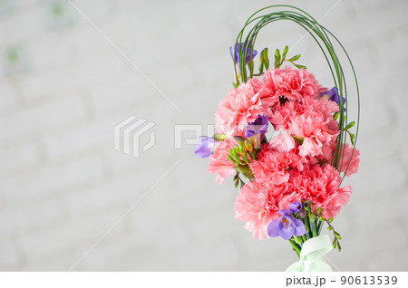 A beautiful composition with pink spray carnations and freesia isolated on a white background 90613539