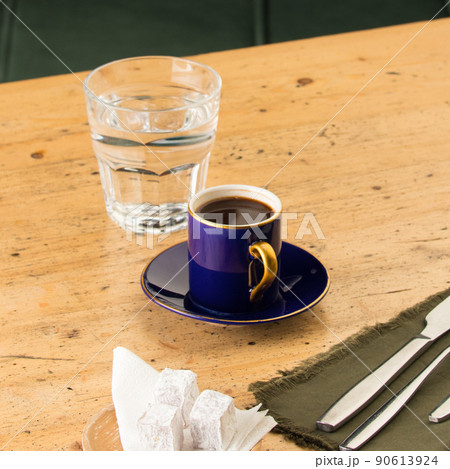 Cup of coffee near glass of water and baklava 90613924