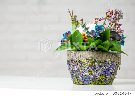 Closeup shot of pot with flowers on white background 90614647