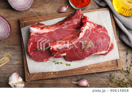 Flat lay composition with fresh beef cut on wooden table 90614808