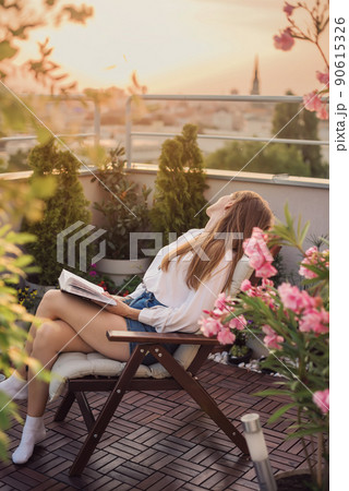 Dreaming Woman with Book on Knees 90615326