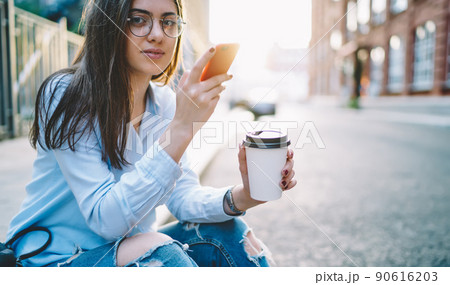 Young female blogger looking at camera using mobile phone and 4G internet Young female blogger looking at camera using mobile phone and 4G internet 90616203