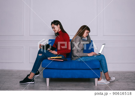Female students doing homework together Female students doing homework together 90616518