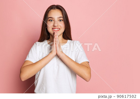 Half-length portrait of young pretty girl in white t-shirt isolated on pink background. Concept of beauty, art, fashion, youth and emotions Half-length portrait of young pretty girl in white t-shirt isolated on pink background. Concept of beauty, art, fashion, youth and emotions 90617502