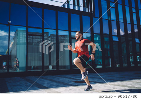 Young sportsman training near building 90617780