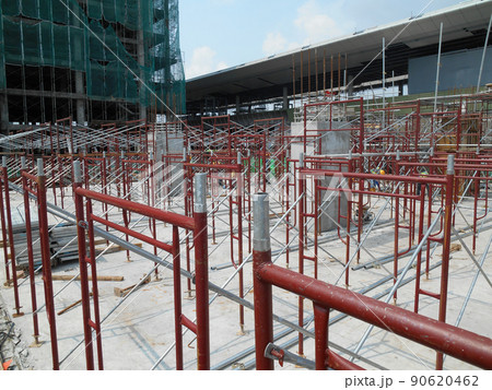 JOHOR, MALAYSIA -APRIL 13, 2016: Scaffolding used as the temporary structure to support platform, form work and structure at the construction site. Also used it as a walking platform for workers. JOHOR, MALAYSIA -APRIL 13, 2016: Scaffolding used as the temporary structure to support platform, form work and structure at the construction site. Also used it as a walking platform for workers. 90620462