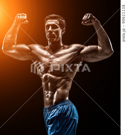 Muscular and fit young bodybuilder fitness male model posing ove 90621138