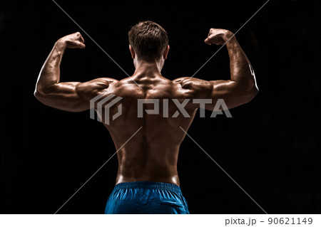 Strong Athletic Man Fitness Model posing back muscles, triceps over black background 90621149