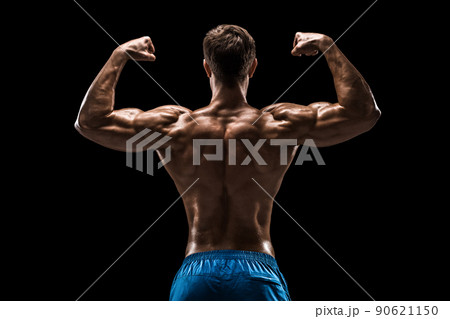 Strong Athletic Man Fitness Model posing back muscles, triceps over black background Strong Athletic Man Fitness Model posing back muscles, triceps over black background 90621150