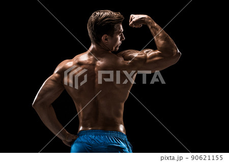 Strong Athletic Man Fitness Model posing back muscles, triceps over black background 90621155