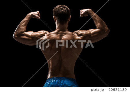 Strong Athletic Man Fitness Model posing back muscles, triceps over black background 90621189