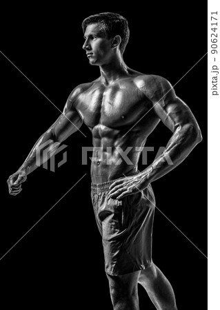 Muscular and fit young bodybuilder fitness male model posing ove 90624171