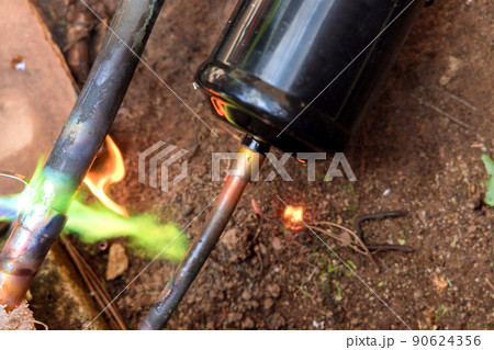 Repairman soldering copper pipe burner for air conditioning repair Repairman soldering copper pipe burner for air conditioning repair 90624356