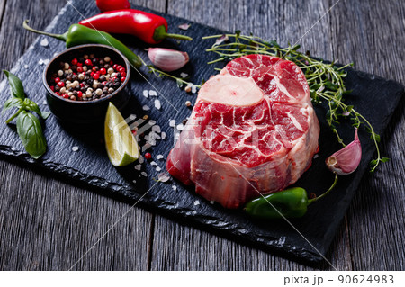 raw osso buco, veal shank steak on stone board 90624983