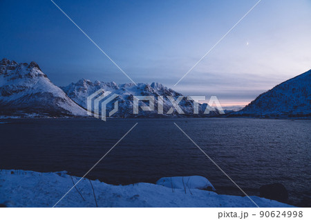 Snowy mountains near water in winter Snowy mountains near water in winter 90624998