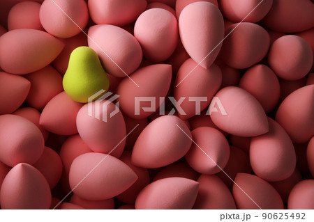 beauty background a bunch of pink gentle sponges and one contrast green conflict for makeup dark key 90625492