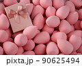 beauty background a bunch of pink gentle makeup sponges and a pink gift 90625494