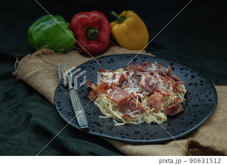 Truffle carbonara spaghetti with fried bacon and grated cheese in ceramic plate. 90631512