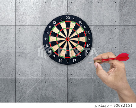 hand holding darts arrow. target for Darts. Concrete wall background. concept marketing target hand holding darts arrow. target for Darts. Concrete wall background. concept marketing target 90632151