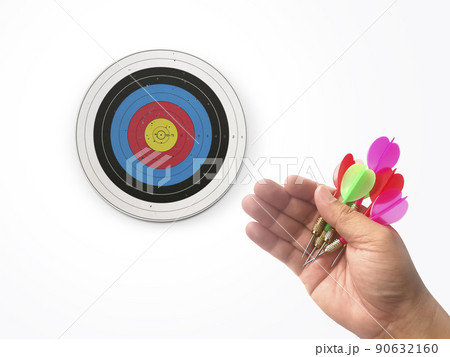 Human hand is throwing the darts target to the darts board. a man's hand throws a dart at the target Human hand is throwing the darts target to the darts board. a man's hand throws a dart at the target 90632160