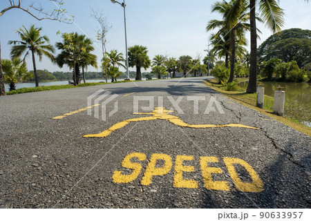 Road for runners with blue sky background,and a large pond. 90633957