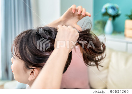 髪をまとめる若い女性 髪をまとめる若い女性 90634266
