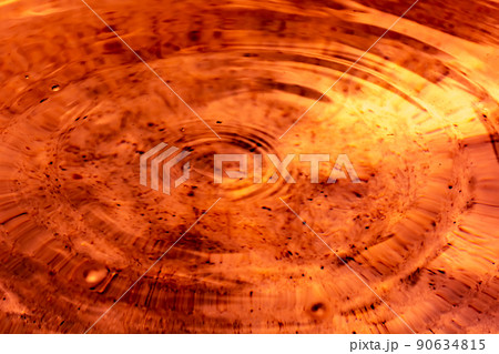 Circles on orange brown fluid 90634815