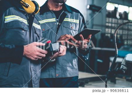 Group of factory job workers using adept machine equipment in a workshop 90636611