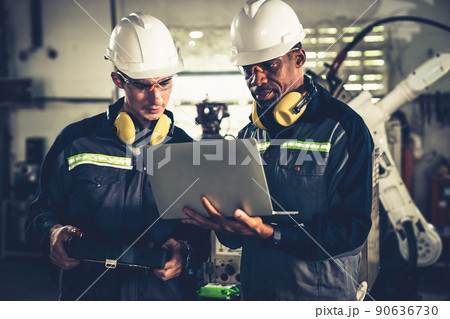 Group of factory job workers using adept machine equipment in a workshop Group of factory job workers using adept machine equipment in a workshop 90636730