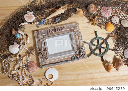 Empty Frame on Wooden Background With Sea Shells and Fishing Net. Nautical and Coastal Theme 90645279