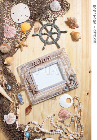 Empty Frame on Wooden Background With Sea Shells and Fishing Net. Nautical and Coastal Theme Empty Frame on Wooden Background With Sea Shells and Fishing Net. Nautical and Coastal Theme 90645308
