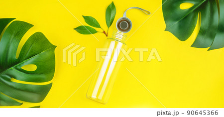 Banner,poster.Reusable glass bottle for water on yellow background.May bottle.Let's go shopping.Ecological, natural materials.The concept zero waste.The view from the top.Life without Plastic. Banner,poster.Reusable glass bottle for water on yellow background.May bottle.Let's go shopping.Ecological, natural materials.The concept zero waste.The view from the top.Life without Plastic. 90645366