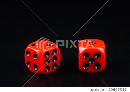 A pair of red dice on black background.close up view 90646331