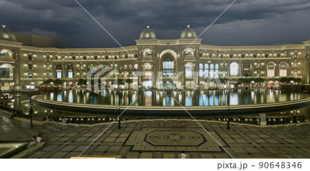 Place Vendome Mall  in Lusail city, Qatar interior view at night showing the architecture of the mall with big fountain in foreground 90648346