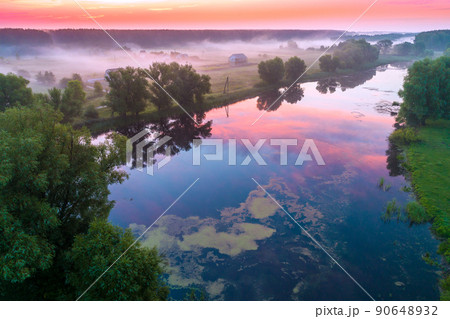Early misty morning, sunrise over the lake. Rural landscape in summer. Aerial view Early misty morning, sunrise over the lake. Rural landscape in summer. Aerial view 90648932