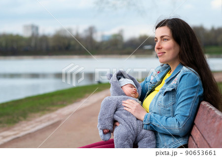 Mom and newborn walk in park 90653661